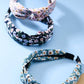 JOSSLYN by wall to wall - FLOWER PRINT KNOTTED HAIR BAND | 40HB243: BLACK